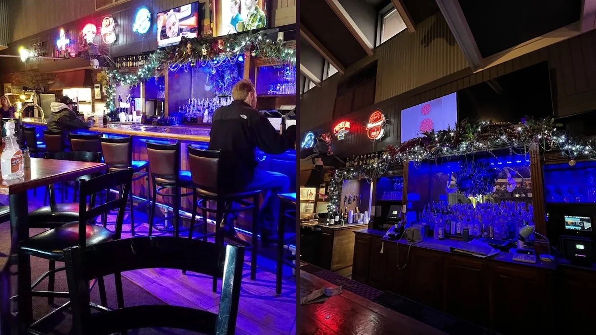 Neighborhood bar interior with simple wooden tables.