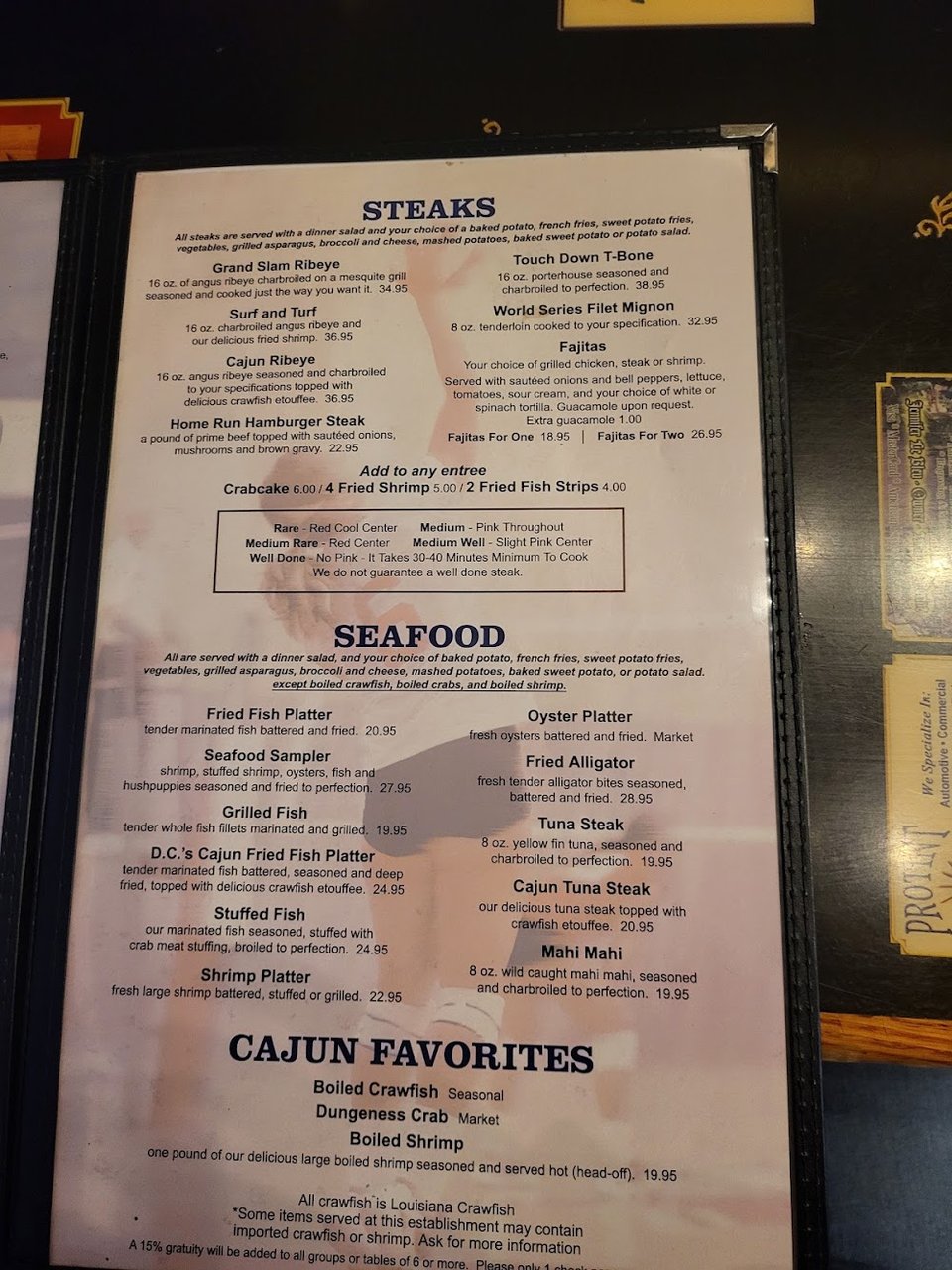 Burger and fried seafood on white plates.